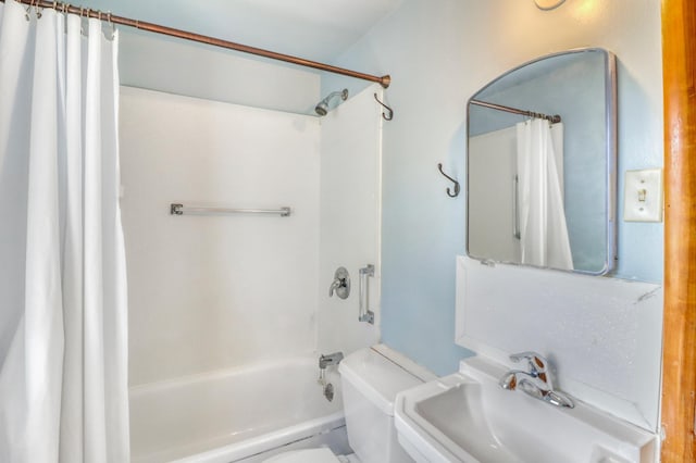 full bath with a sink, shower / tub combo with curtain, and toilet