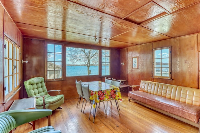dining room featuring wood ceiling, a wealth of natural light, and hardwood / wood-style flooring