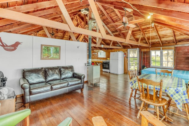 living room with wood-type flooring, a ceiling fan, and lofted ceiling