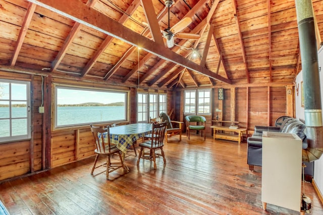 dining space with lofted ceiling with beams, wood ceiling, and wood-type flooring