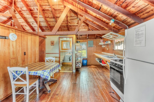 kitchen with wood ceiling, lofted ceiling with beams, freestanding refrigerator, and gas range