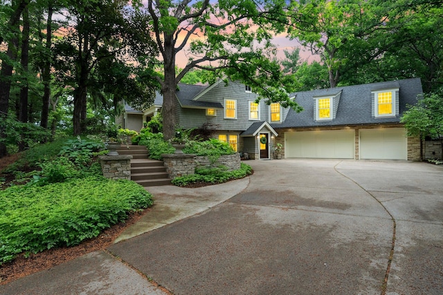 6601 Blackfoot Pass, Edina, MN 55439 - view of front facade with stone siding, concrete driveway, a garage, and a shingled roof