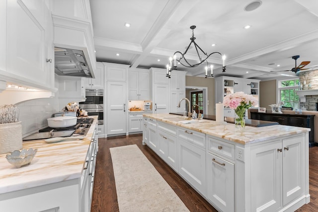 6601 Blackfoot Pass, Edina, MN 55439 - kitchen featuring stainless steel double oven, gas cooktop, beam ceiling, a sink, and ceiling fan with notable chandelier