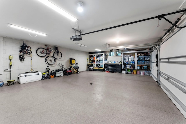 6601 Blackfoot Pass, Edina, MN 55439 - garage featuring a garage door opener and concrete block wall