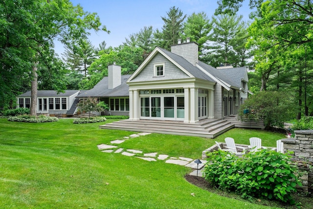 6601 Blackfoot Pass, Edina, MN 55439 - rear view of house featuring an outdoor fire pit, a chimney, a deck, and a yard