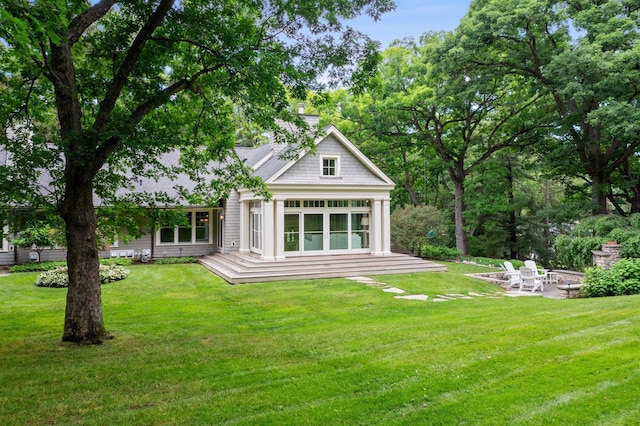 6601 Blackfoot Pass, Edina, MN 55439 - back of property with a chimney, a yard, a deck, and a patio area