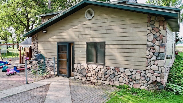 25234 Wall Lake Loop, Fergus Falls, MN 56537 - view of home's exterior with stone siding and a patio area