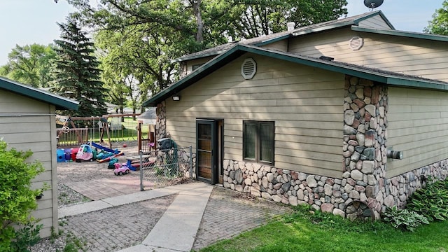25234 Wall Lake Loop, Fergus Falls, MN 56537 - view of property exterior featuring stone siding and a patio
