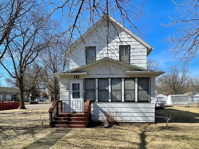 american foursquare style home with fence