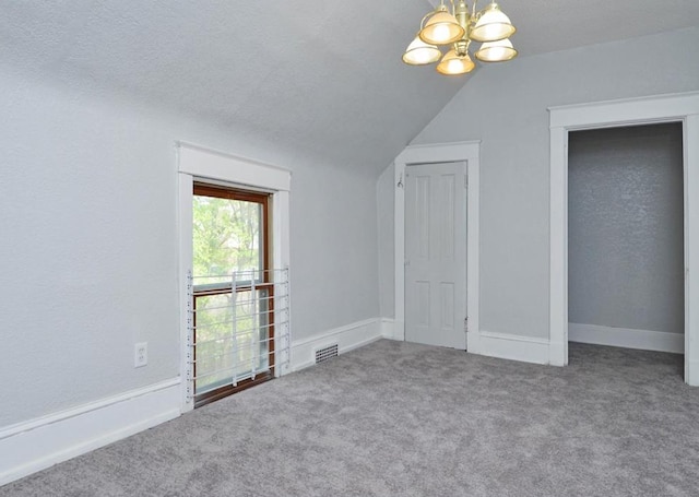 665 Bedford St, Saint Paul, MN 55130 - unfurnished bedroom featuring carpet, a chandelier, and lofted ceiling