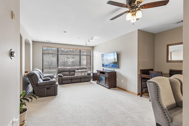 294 Spring St, Saint Paul, MN 55102 - living room with light colored carpet, ceiling fan, and arched walkways