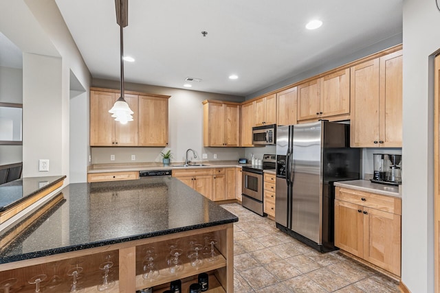 294 Spring St, Saint Paul, MN 55102 - kitchen with appliances with stainless steel finishes, light brown cabinets, pendant lighting, recessed lighting, and dark stone countertops