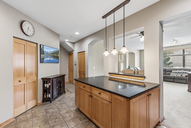 294 Spring St, Saint Paul, MN 55102 - kitchen with open floor plan, arched walkways, pendant lighting, ceiling fan, and light colored carpet