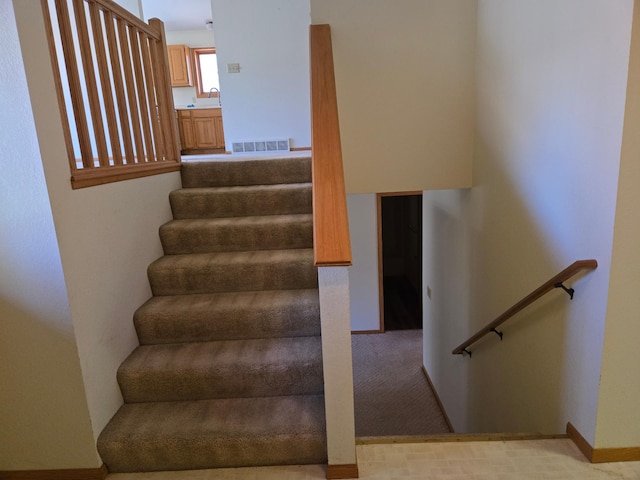stairway featuring visible vents