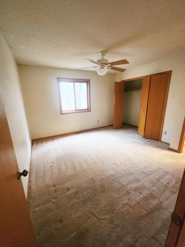 14595 Lynndale Ln, Baxter, MN 56425 - unfurnished bedroom featuring a closet, a textured ceiling, light carpet, and a ceiling fan