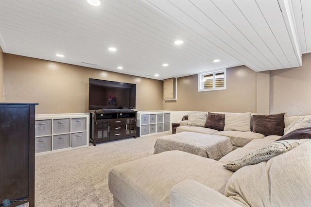 carpeted living area with a textured wall and recessed lighting