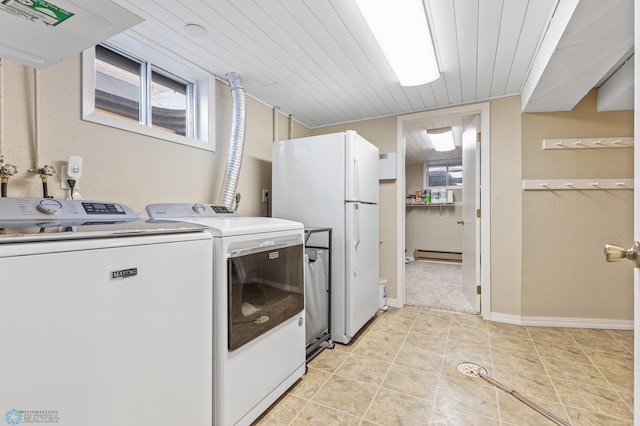 washroom featuring washing machine and dryer, wood ceiling, laundry area, light tile patterned floors, and baseboards