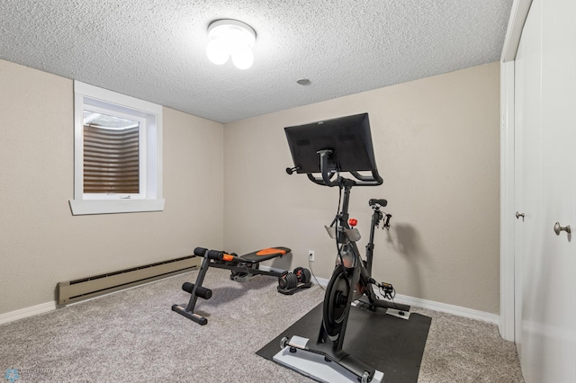 workout area featuring baseboards, baseboard heating, carpet flooring, and a textured ceiling
