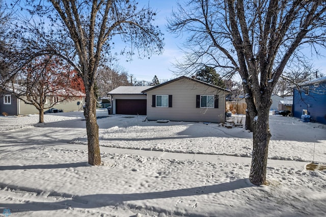 view of front of home with fence and an attached garage