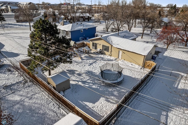 snowy aerial view with a residential view