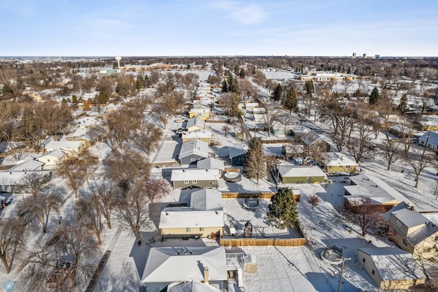 snowy aerial view with a residential view