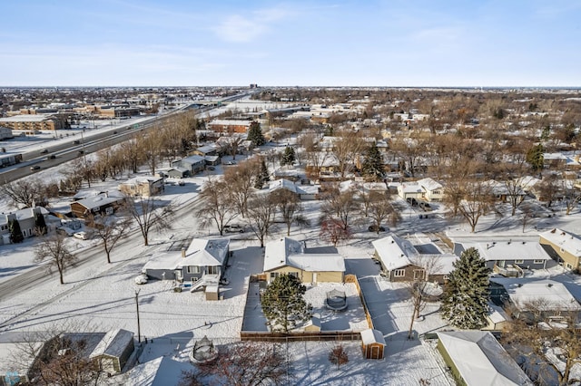 snowy aerial view with a residential view