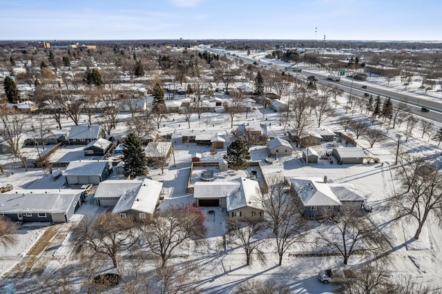 snowy aerial view with a residential view