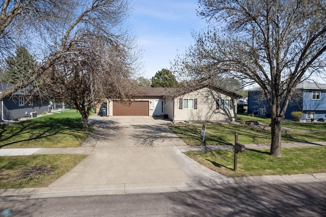 1922 18th St S, Fargo, ND 58103 - view of front of house with driveway, an attached garage, and a front lawn