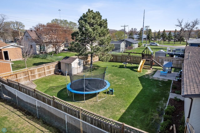 1922 18th St S, Fargo, ND 58103 - view of yard featuring a trampoline, a playground, a storage shed, an outdoor structure, and a residential view