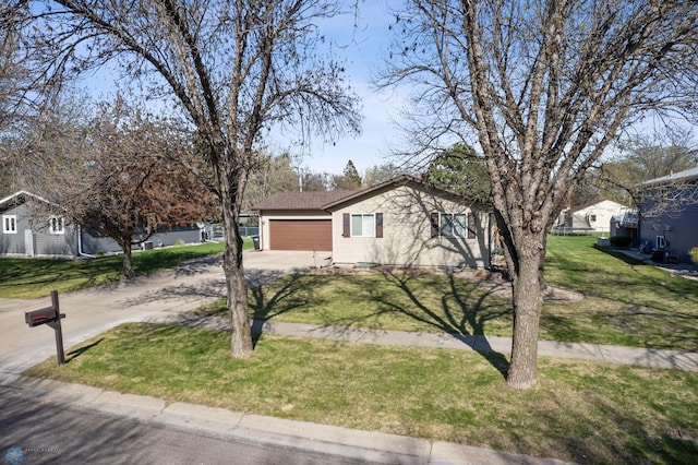 1922 18th St S, Fargo, ND 58103 - view of side of home featuring concrete driveway, a lawn, and an attached garage