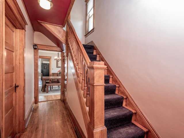 115 Geranium Ave W, Saint Paul, MN 55117 - stairs featuring a chandelier and wood-type flooring