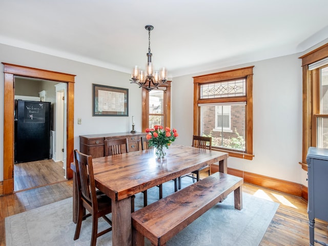 115 Geranium Ave W, Saint Paul, MN 55117 - dining space with a chandelier and light wood-type flooring