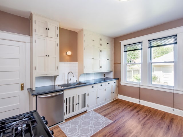 115 Geranium Ave W, Saint Paul, MN 55117 - kitchen featuring stainless steel dishwasher, light wood finished floors, decorative backsplash, dark countertops, and white cabinetry