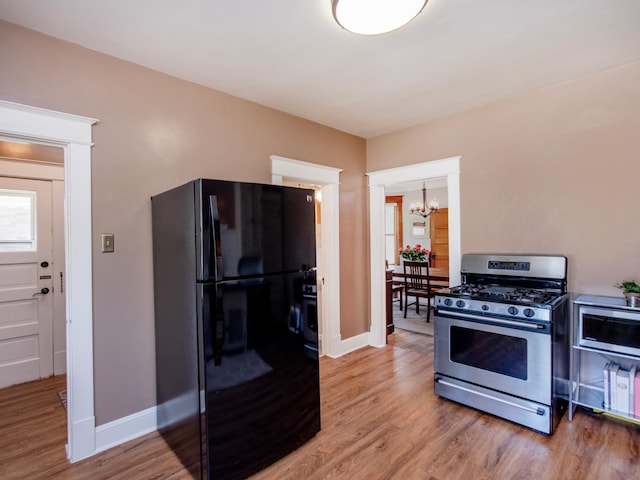 115 Geranium Ave W, Saint Paul, MN 55117 - kitchen featuring stainless steel appliances, a chandelier, and light wood-type flooring