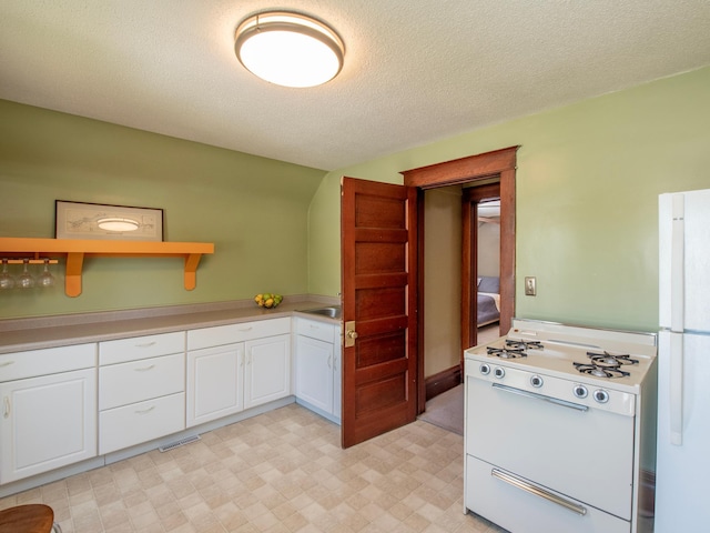 115 Geranium Ave W, Saint Paul, MN 55117 - kitchen with white appliances, white cabinetry, open shelves, light countertops, and a textured ceiling