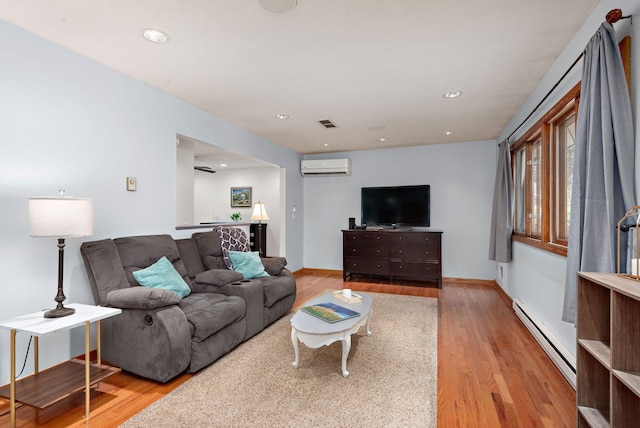 113 Oak Ave SW, Saint Michael, MN 55376 - living room with a baseboard radiator, a wall mounted air conditioner, wood finished floors, and recessed lighting