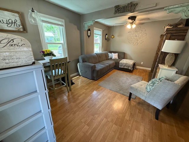 328 Jefferson Pl, Faribault, MN 55021 - living area featuring light wood finished floors, ceiling fan, and baseboards