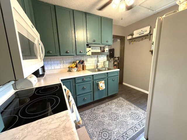 328 Jefferson Pl, Faribault, MN 55021 - kitchen featuring white appliances, green cabinets, a sink, light countertops, and a textured ceiling