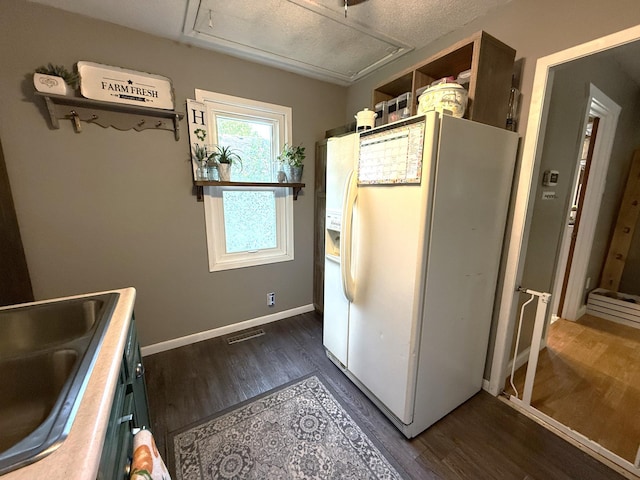 328 Jefferson Pl, Faribault, MN 55021 - kitchen featuring white refrigerator with ice dispenser, dark wood finished floors, open shelves, a sink, and baseboards