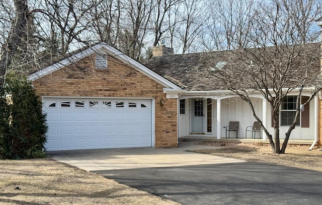 ranch-style house featuring an attached garage, a chimney, concrete driveway, brick siding, and covered porch