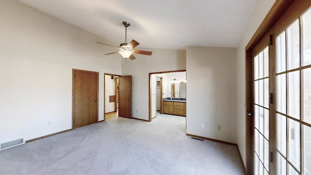 unfurnished bedroom with baseboards, ensuite bath, visible vents, and light carpet