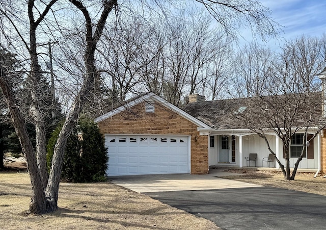 ranch-style home with an attached garage, driveway, brick siding, a porch, and a chimney