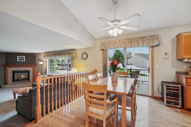 579 Maple Knoll Cir NW, Saint Michael, MN 55376 - dining room with wine cooler, healthy amount of natural light, light wood-type flooring, ceiling fan, and vaulted ceiling