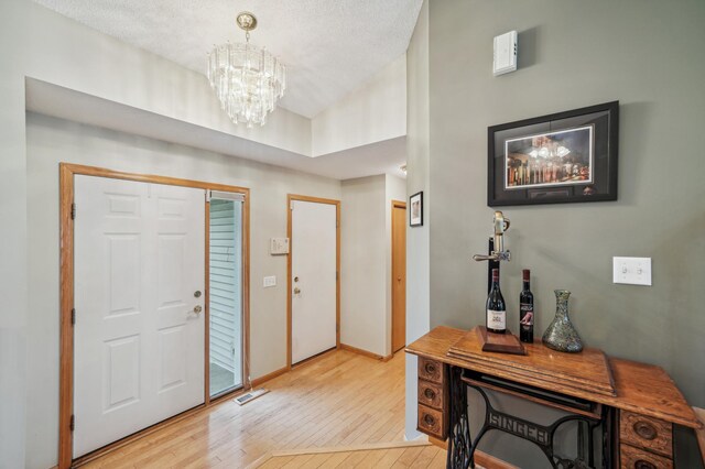 579 Maple Knoll Cir NW, Saint Michael, MN 55376 - entrance foyer with light wood-type flooring and a chandelier