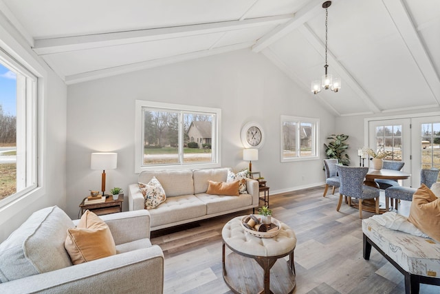 12005 Stacy Trl, Lindstrom, MN 55013 - living room featuring lofted ceiling with beams, baseboards, wood finished floors, and a notable chandelier