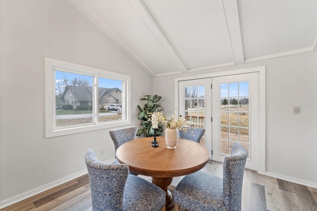12005 Stacy Trl, Lindstrom, MN 55013 - dining space featuring vaulted ceiling with beams, light wood-style flooring, and baseboards