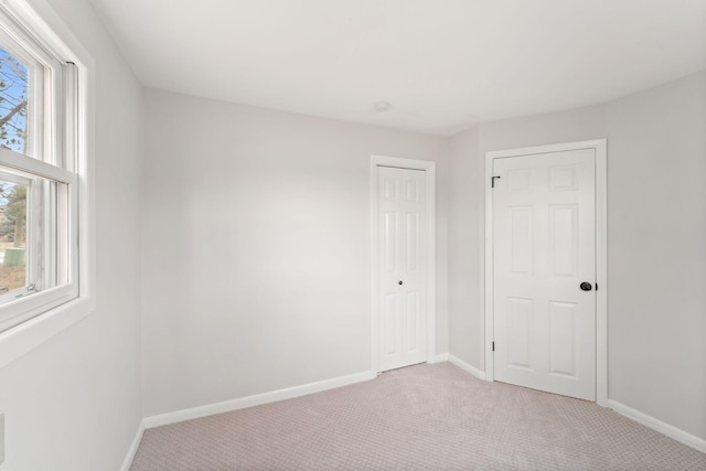 12005 Stacy Trl, Lindstrom, MN 55013 - unfurnished bedroom featuring baseboards, a closet, and light colored carpet
