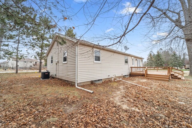 12005 Stacy Trl, Lindstrom, MN 55013 - exterior space featuring central AC unit, crawl space, and a deck
