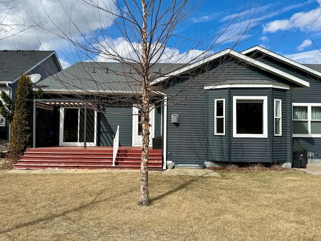 back of property featuring a yard