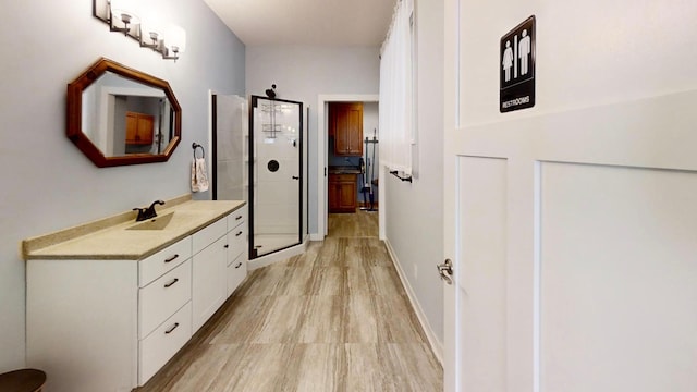 corridor featuring baseboards and a sink